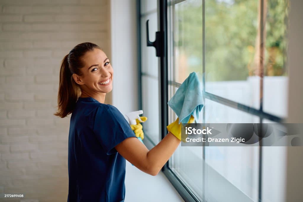 A man cleaning a window.