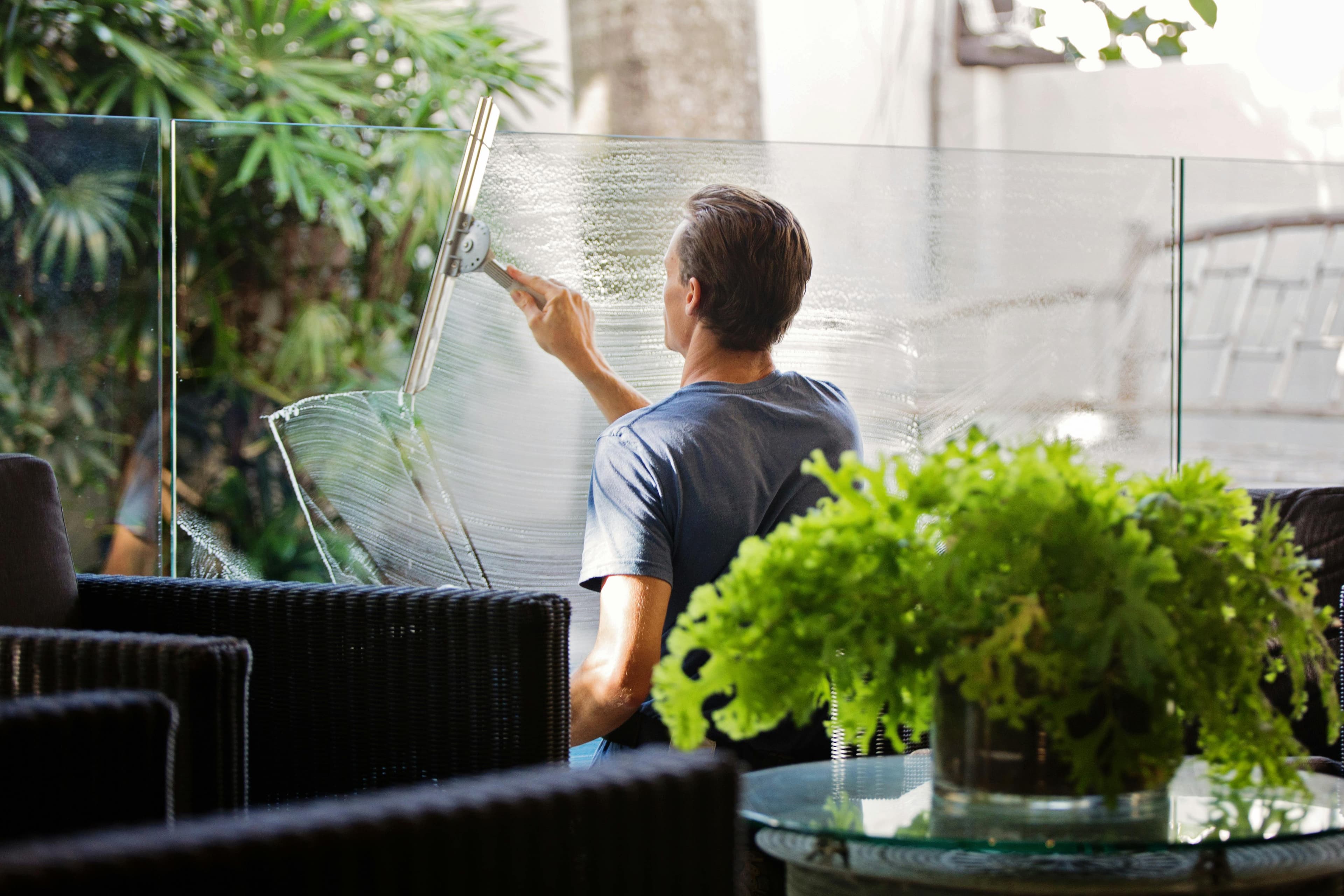 A man cleaning a window.