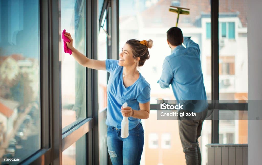 A man cleaning a window.