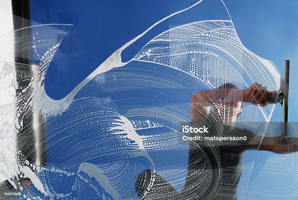 A man cleaning a window.